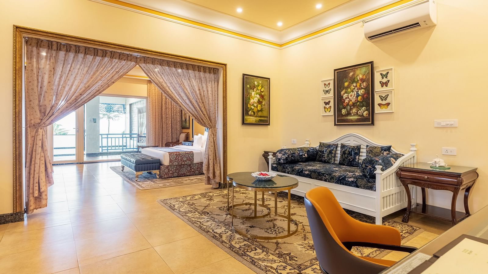 Spacious living area with classic decor, elegant furniture, and warm lighting at MAYFAIR Palm Beach Resort, Gopalpur-On-Sea.