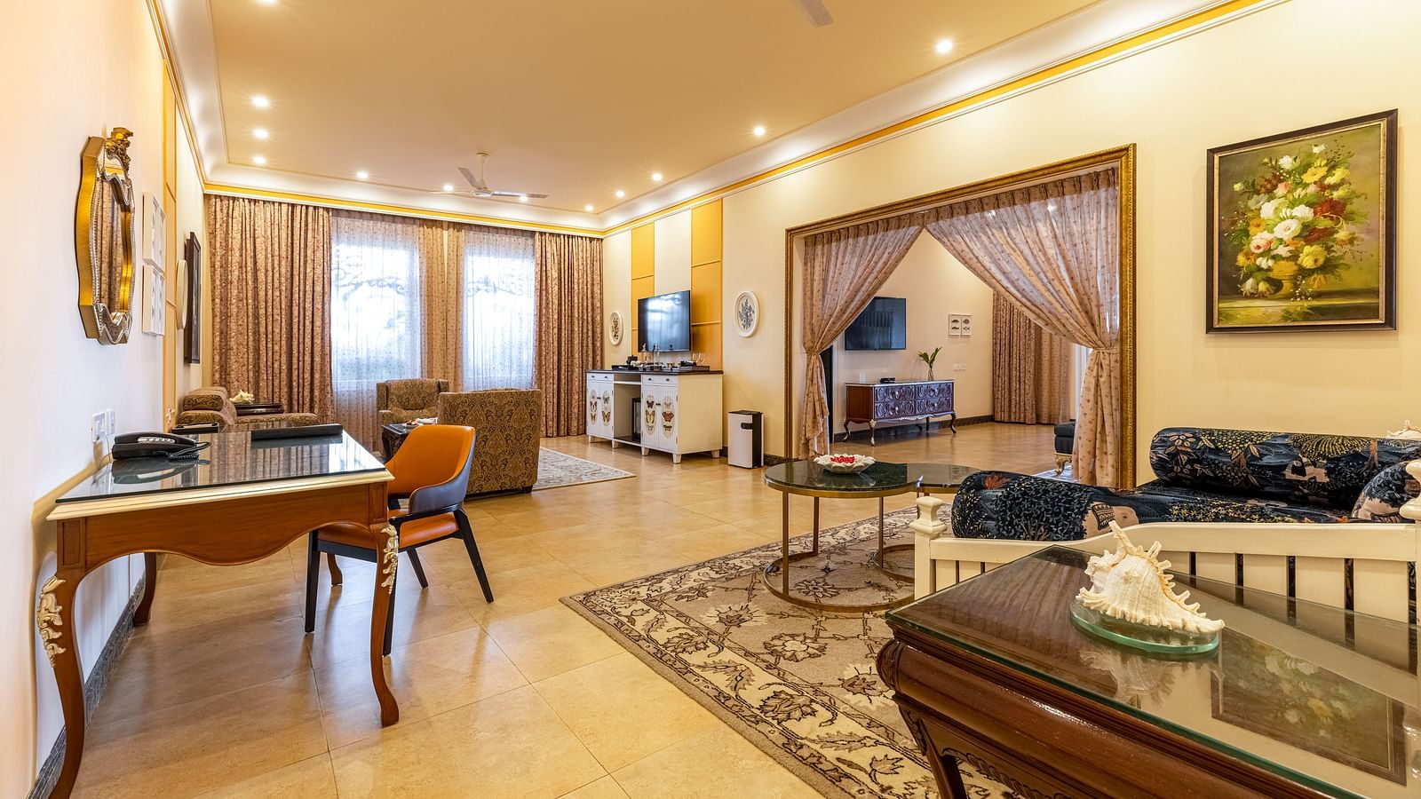  Luxurious suite with living and dining area, classic interiors, and traditional artwork at MAYFAIR Palm Beach Resort, Gopalpur-On-Sea.