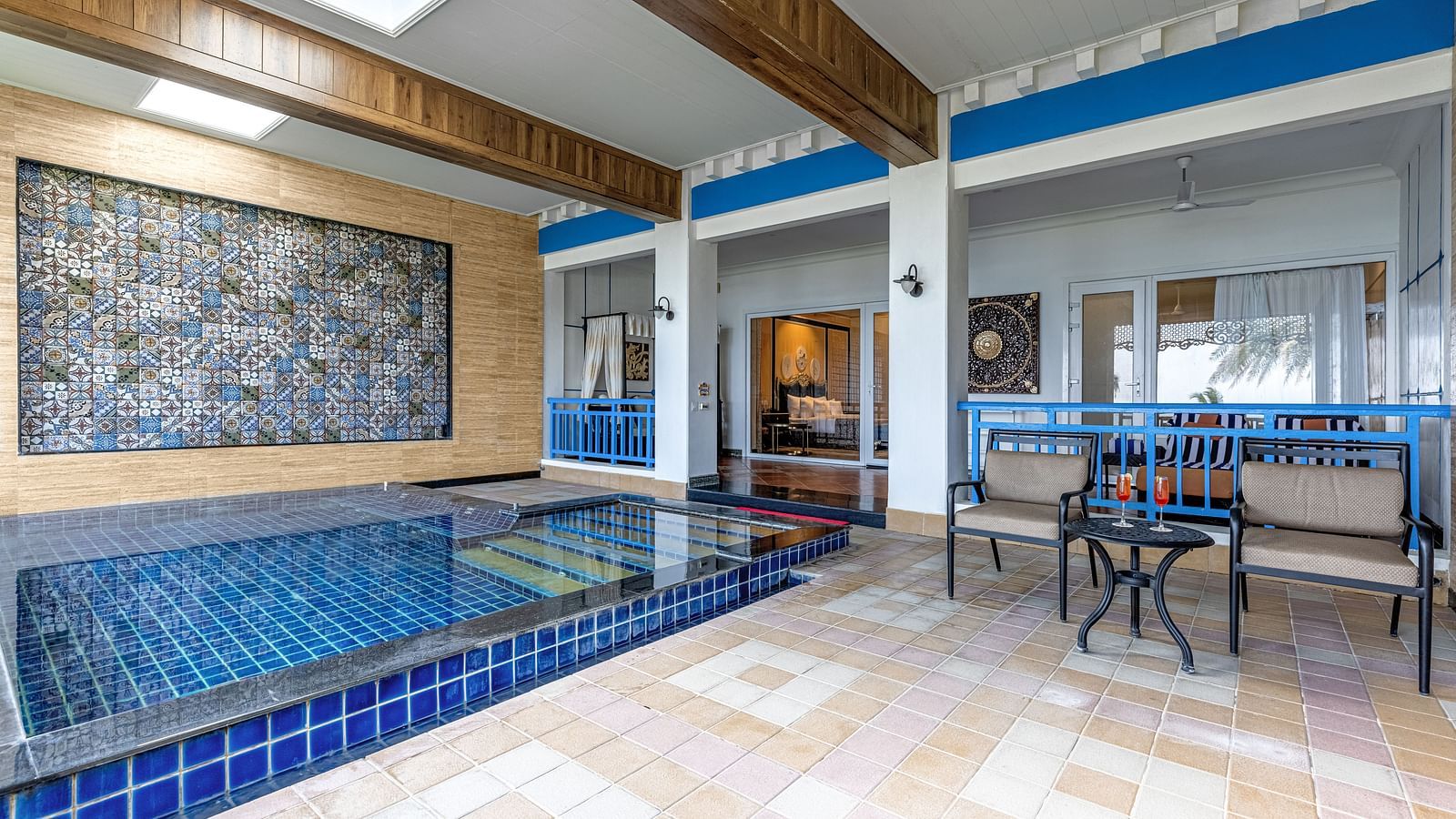 Indoor pool area with tilework and lounging space at MAYFAIR Palm Beach Resort, Gopalpur-on-Sea