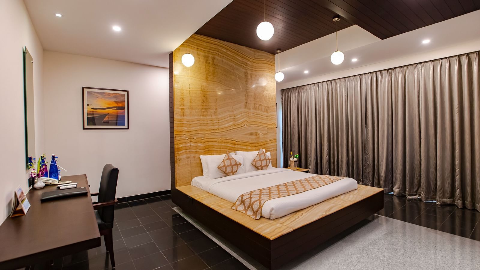 GRANDEUR BED ROOM featuring plush bed and work table at MGM Beach Resorts 