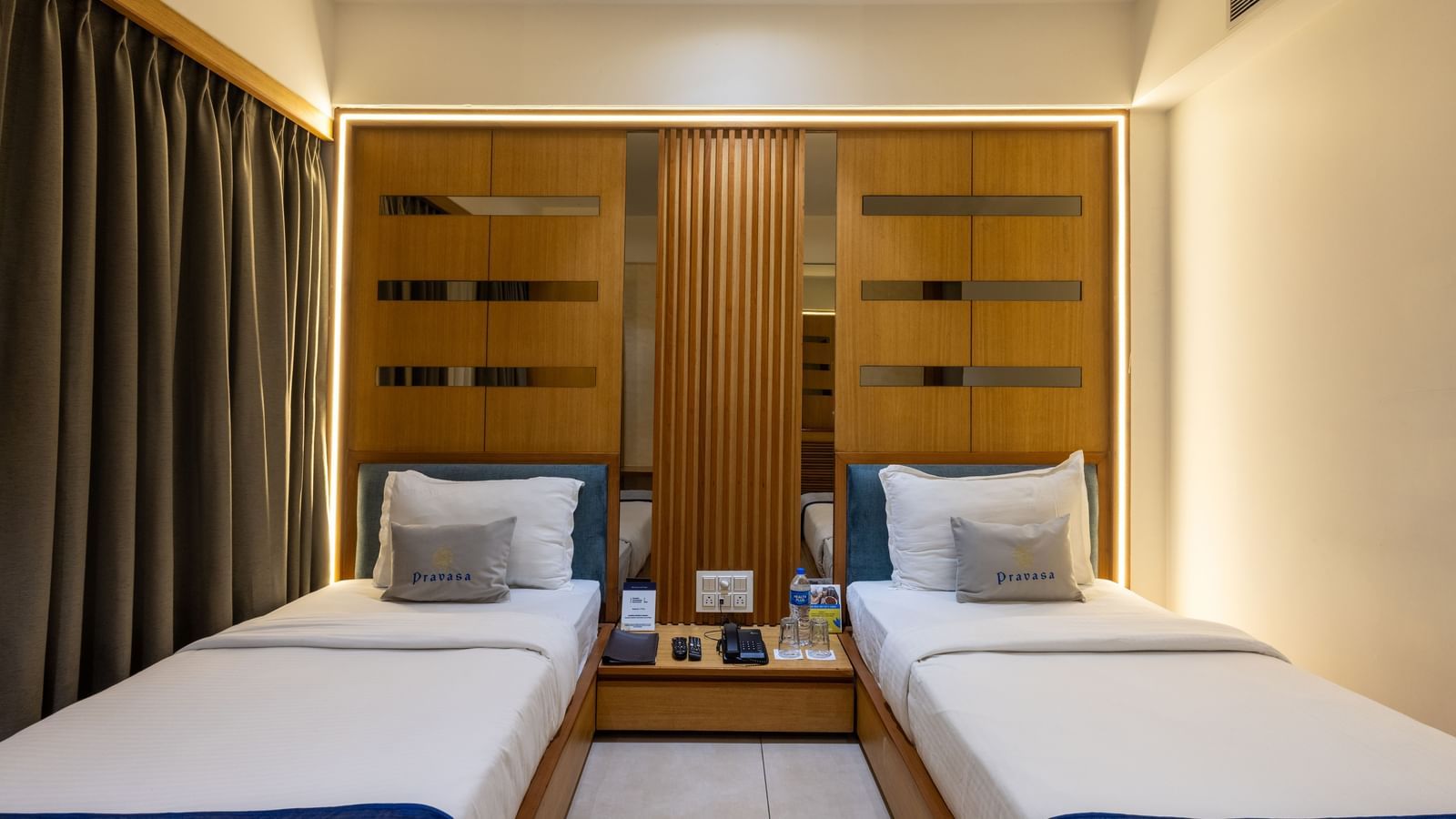 Twin beds highlighted with a central placement in the Superior Room of Pravasa Stay Vijay Nagar, Indore.
