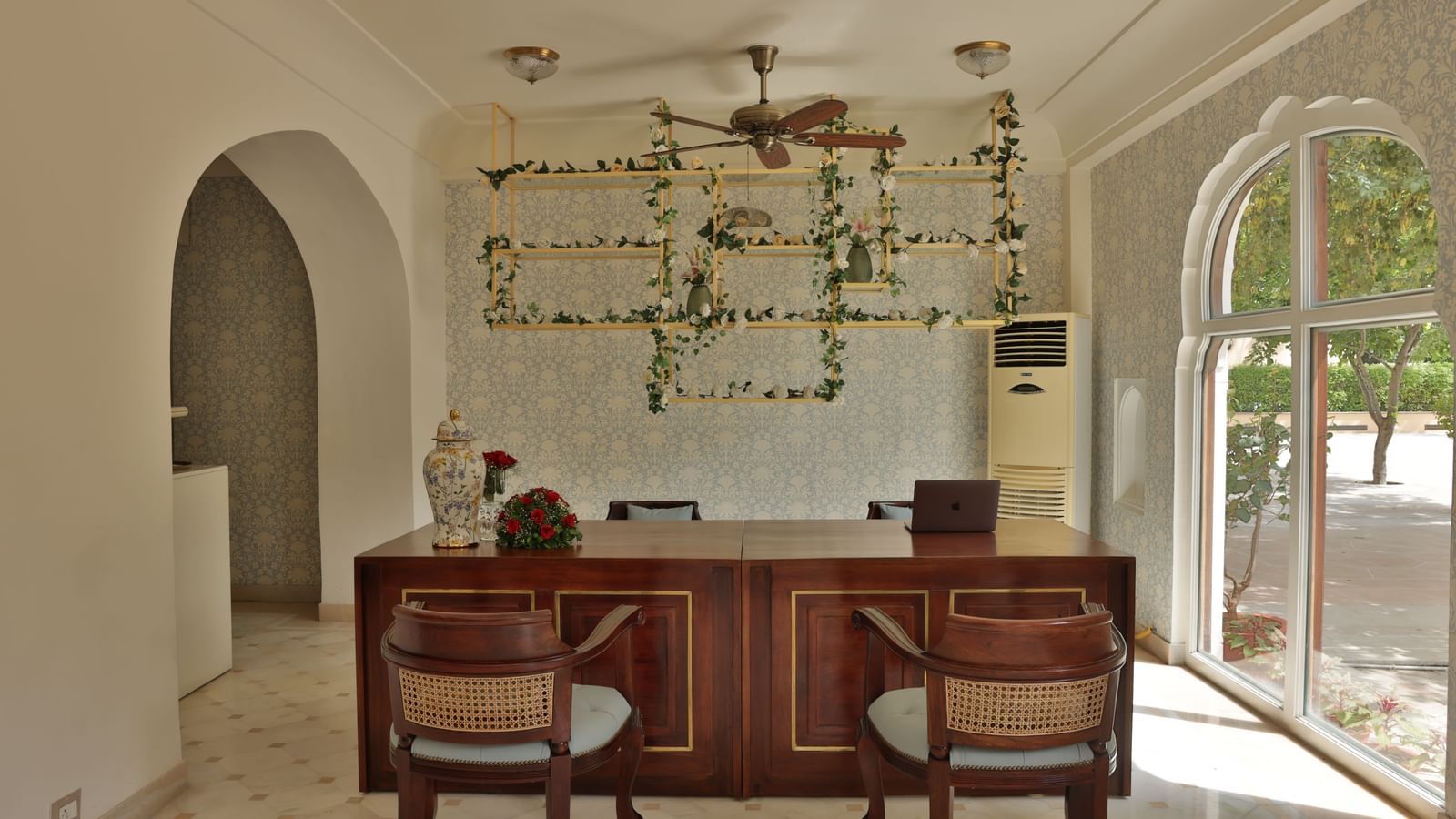 An interior room with a wooden table, chairs, and decorative elements at Royal Heritage Haveli.