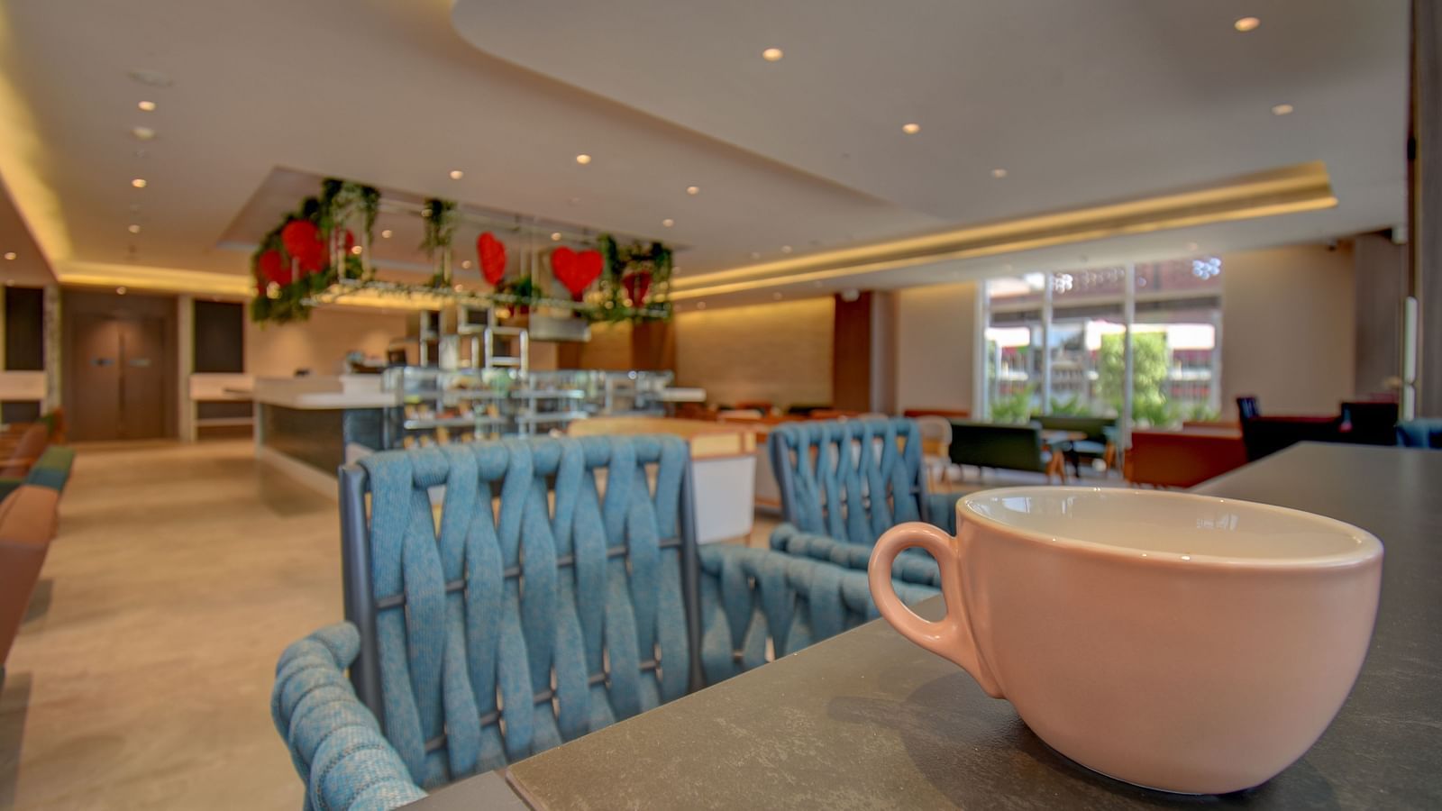 Close up of two sister's cafe The SSK Solitaire Boutique Hotel & Spa, Gangapur Road - Nashik featuring chair, tables and a cup