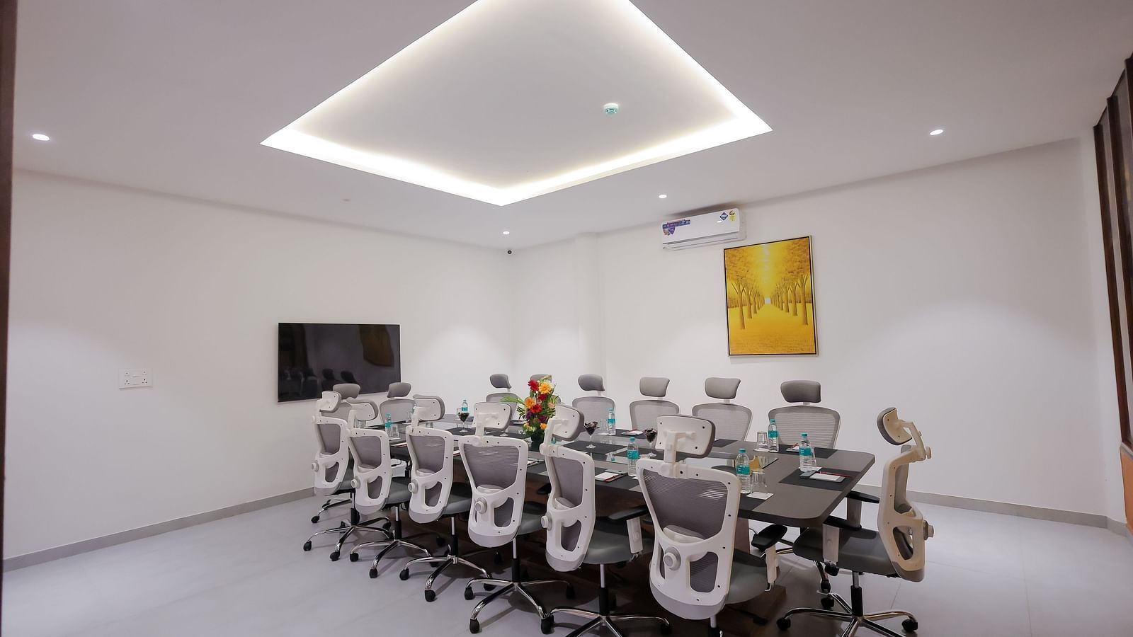 Minimalist boardroom at Trishvam Symphony, Krishnagiri, ideal for formal meetings with clean design and ergonomic chairs.