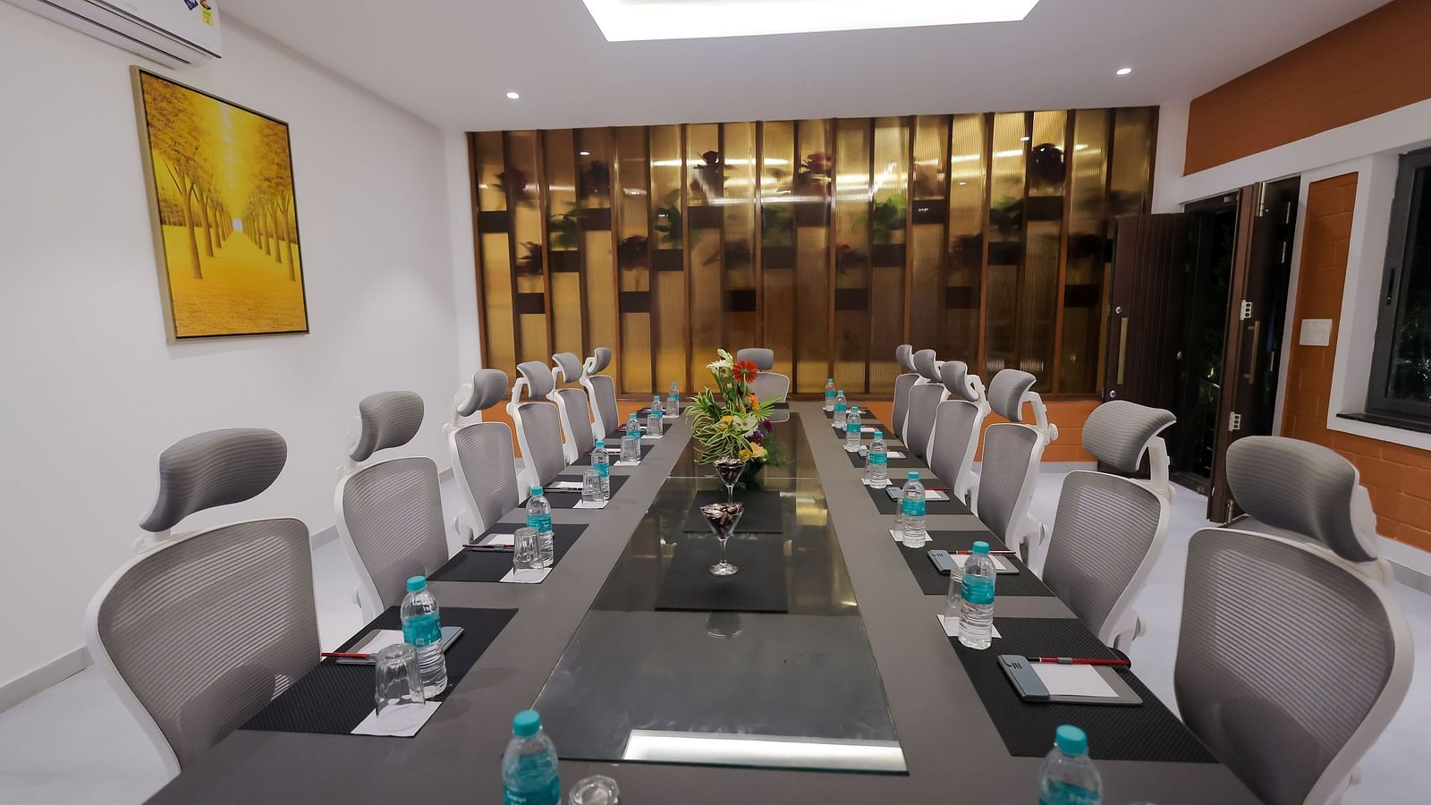 Modern boardroom at Trishvam Symphony, Krishnagiri, set with executive chairs, water bottles, and a professional meeting setup.