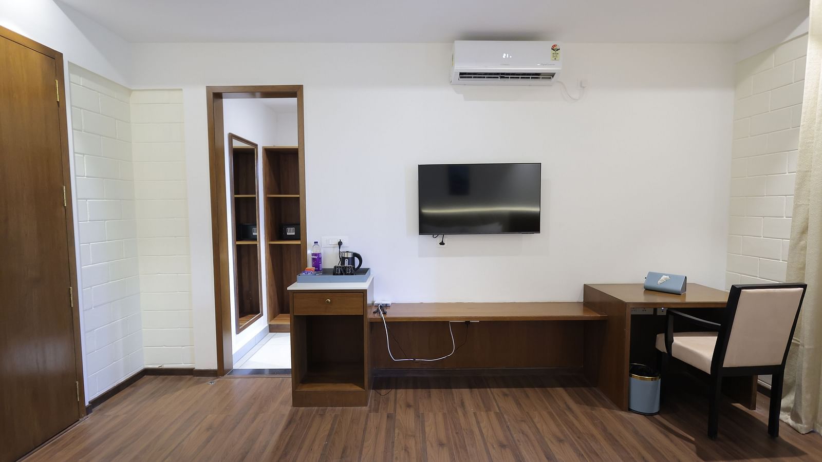 Room with TV area, dual workstations, chairs, and storage cabinets at Trishvam Symphony, Krishnagiri.