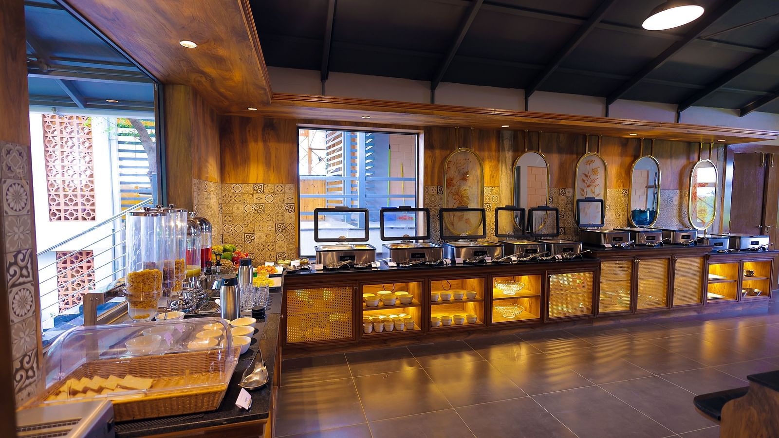 Buffet counter setup in a stylish wooden-themed dining area at Trishvam Symphony, Krishnagiri.