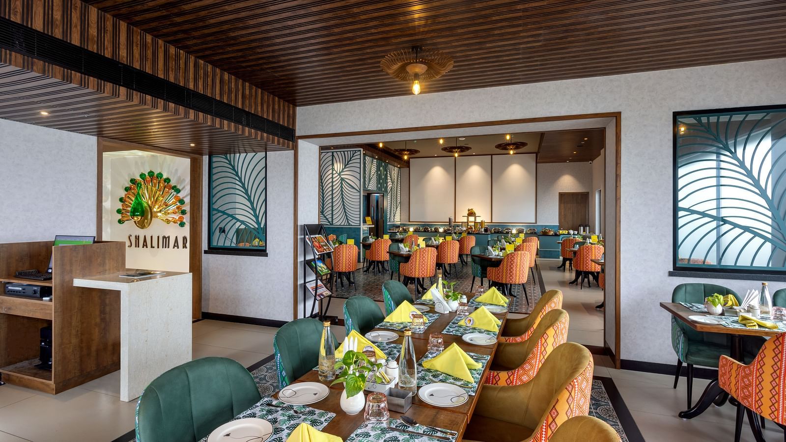 Front view of Shalimar Restaurant at Zibe Luxe Hyderabad by GRT Hotels with its name emblem, tastefully set tables, and welcoming atmosphere.