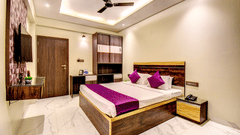 Super Deluxe Room wide view with king bed, wardrobe, TV and marble flooring at VITS Select Kharadi Pune