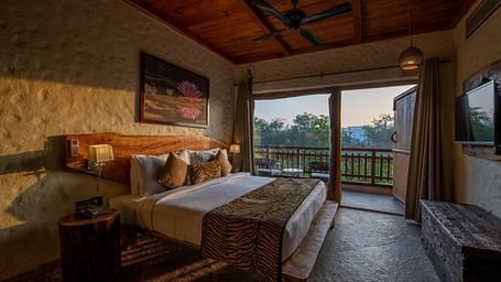 view of the bed beside the balcony offered by one of the rooms in Ranthambore