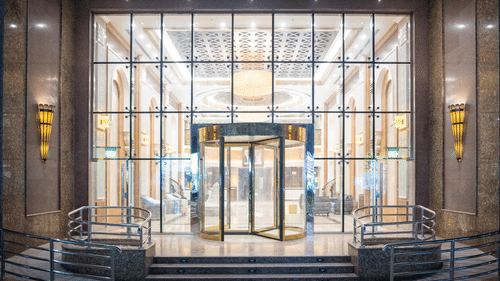 Patterned glass entrance with steps at La Maison Hotel, Doha.