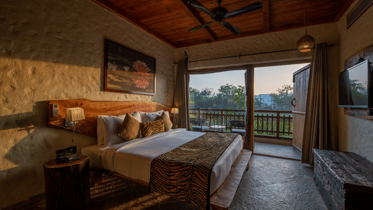 view of the bed beside the balcony offered by one of the rooms in Ranthambore