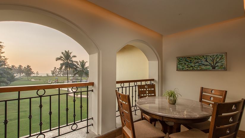 The Sea View Suite Outdoor Dining Table looks pristine in a white setting with  an open view to the lawn and trees outside