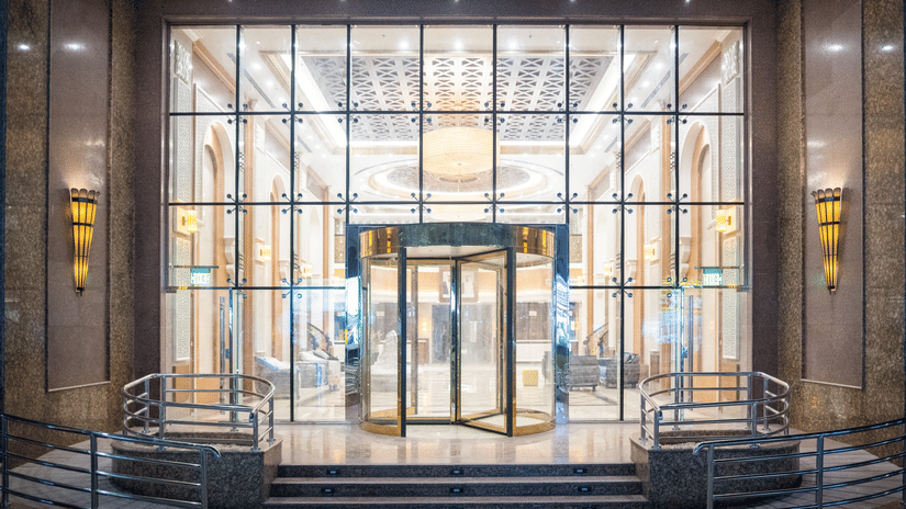 Patterned glass entrance with steps at La Maison Hotel, Doha.