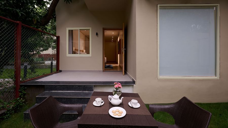 tea and biscuits on a table in the lawn of the Cottage at ABN Sarovar Portico, Jim Corbett