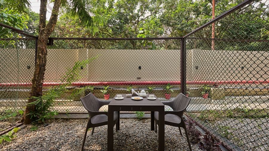 patio furniture in the Sit-out area of the Deluxe Room at ABN Sarovar Portico, Jim Corbett