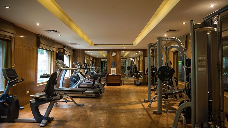 Fully equipped gym at Ananta Spa & resort, Pushkar featuring equipment including ellipticals, tradmills, cycling and weight lifts 
