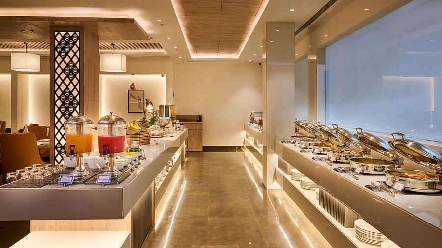 An image with seating facility on its left and buffet facility on the right at our restaurant
