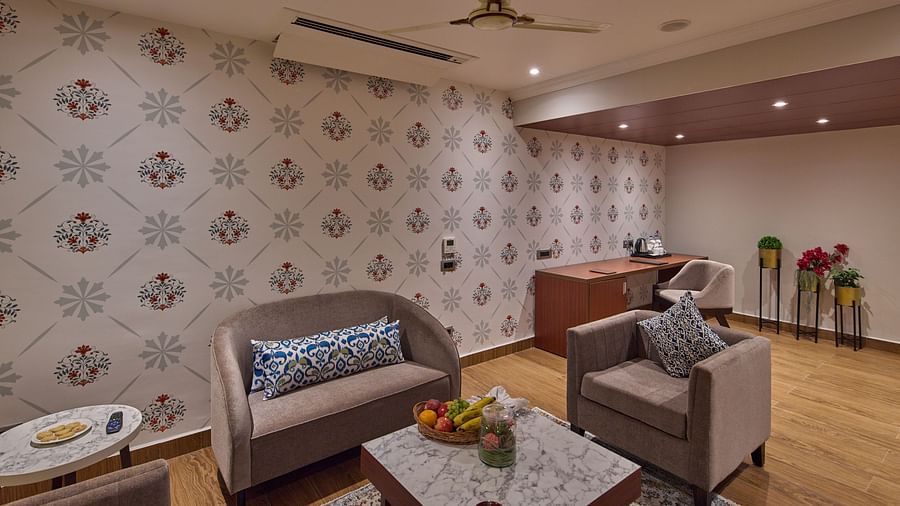 the living area with sofa sets and a table in the suite - Golden Tulip, Tirupati 