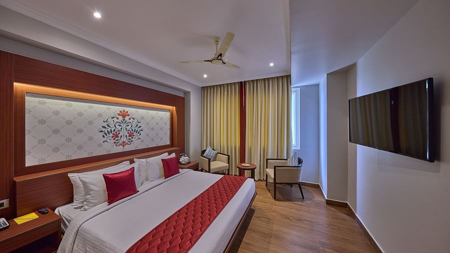 a king size bed overlooking the tv - Golden Tulip, Tirupati 