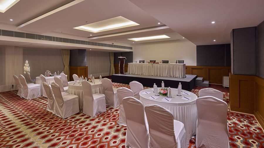 chairs with white cloths set up in a cluster arrangement in Mandapa, the ballroom at Grand Continent, Mahabalipuram