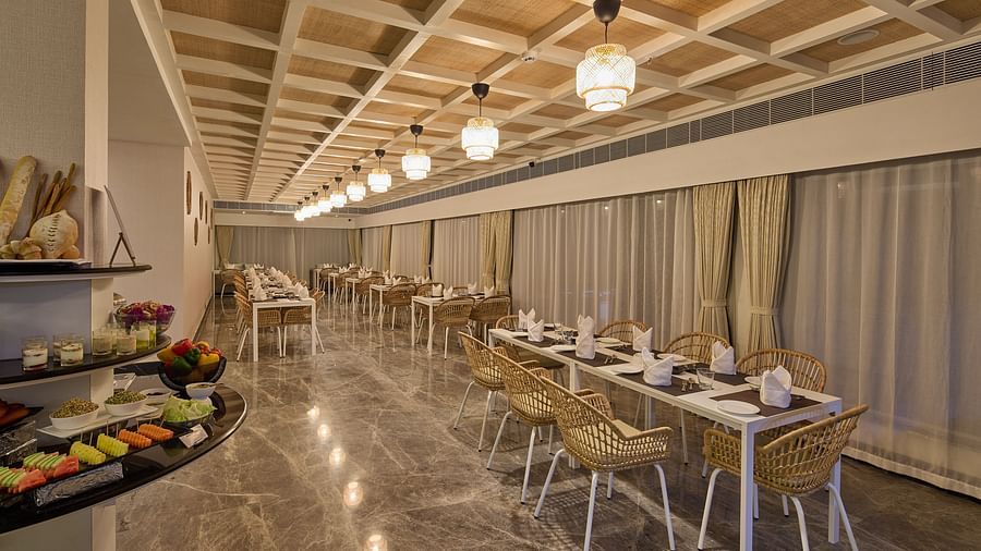 tables and chairs beside a buffet station in our restaurant in Mahabalipuram - Grand Continent, Mahabalipuram