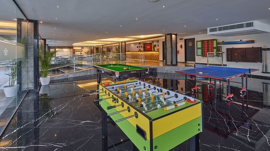 a pool table, foosball table, and table tennis table in the indoor games section of our hotel - Grand Continent, Mahabalipuram