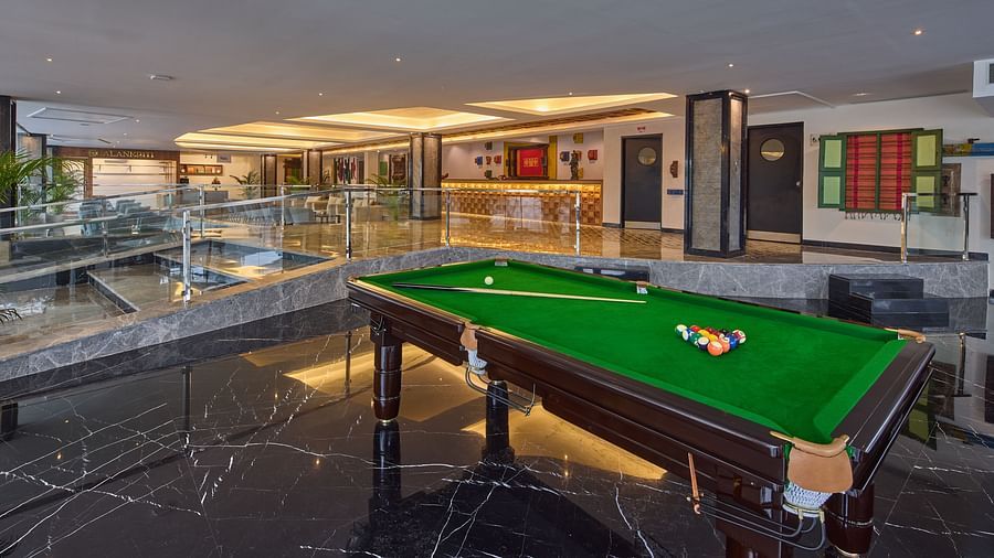 a cue and balls on a pool table in the indoor games section of Grand Continent, Mahabalipuram