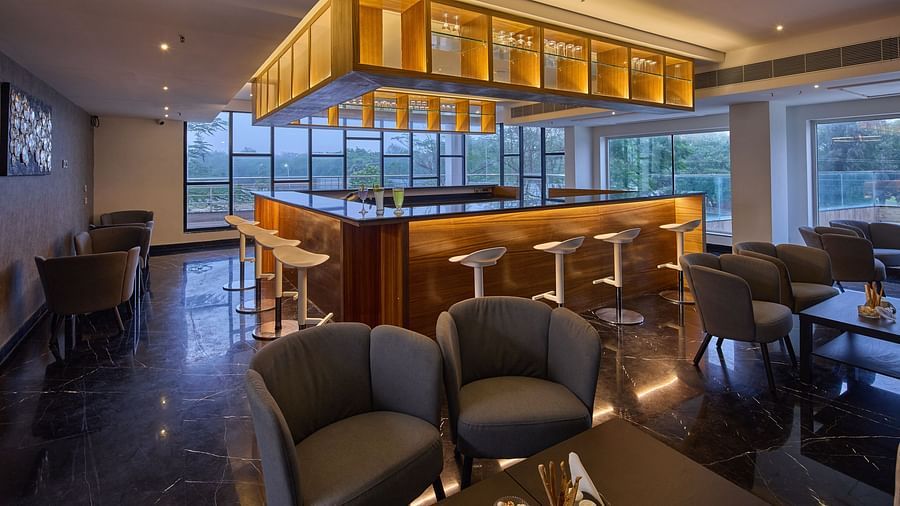 two chairs in front of the bar area at Unwind Kitchen and Bar at Grand Continent, Mahabalipuram
