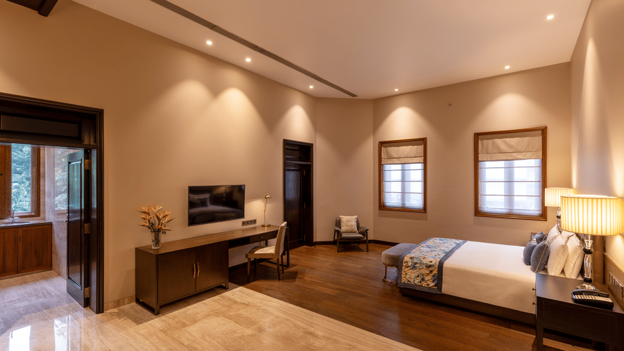 Premier Club Suite with a bed, lounge seating and television unit at Kenilworth Hotel, Kolkata