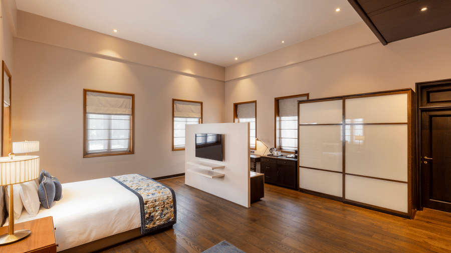 Premium Club Room with a bed and sliding wardrobe doors at Kenilworth Hotel, Kolkata.