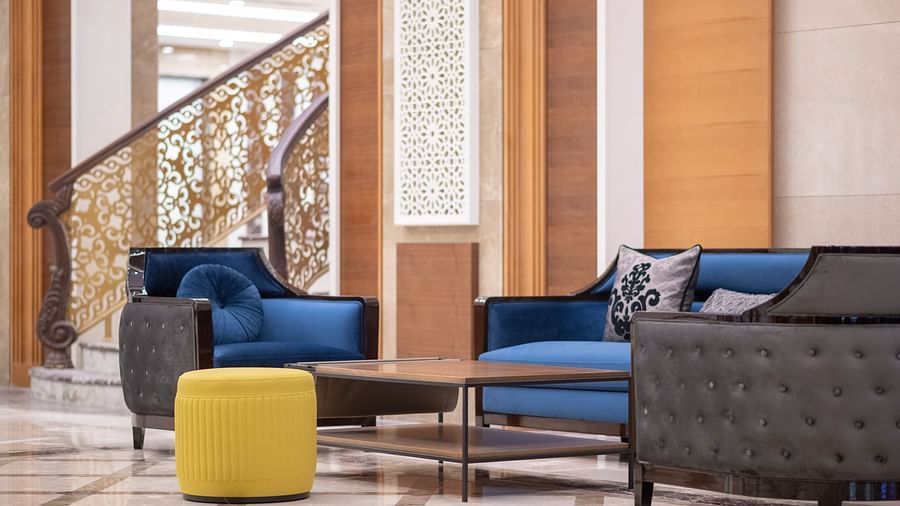 sofas in the lobby with a coffee table kept in the centre - La Maison Hotel, Doha