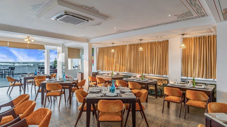 Seating arrangements inside the in-house restaurant at Maan Vilas by Stone Wood, Udaipur