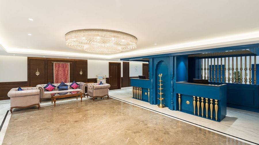 Spacious reception area with a grand chandelier and elegant seating at our hotel - MJ Sarovar Portico, Haridwar