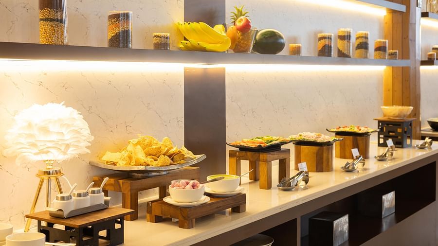 A close-up view of a well-presented buffet table with an assortment of snacks and desserts - Pride Premier Dehradun
