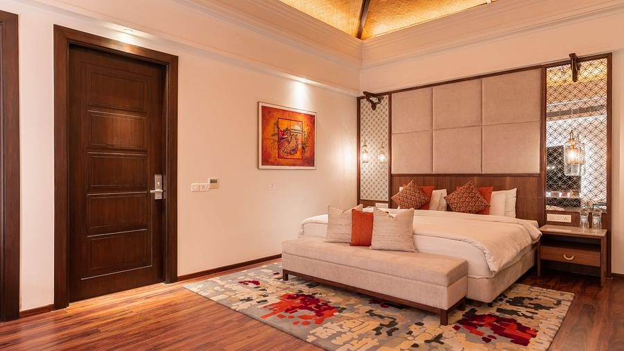 A king size bed with ottoman at the end at the Ananta Villa - The Ananta Udaipur