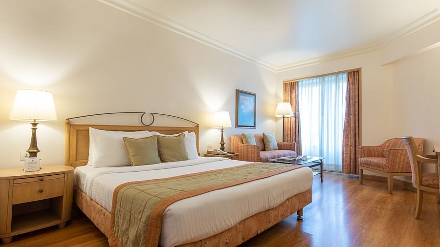 room with king size bed and wooden flooring at the orchid hotel mumbai - The Orchid Hotel Mumbai Vile Parle
