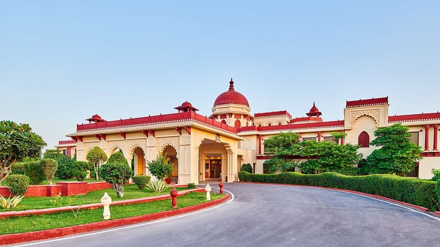 entry way to our hotel with green trees around - The Ummed Jodhpur, Palace Resort and Spa