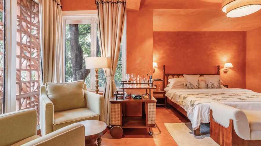 Bedroom at Unseen Boutique Hotel with white linens, large windows, and soft lighting creating a bright and comfortable ambience.