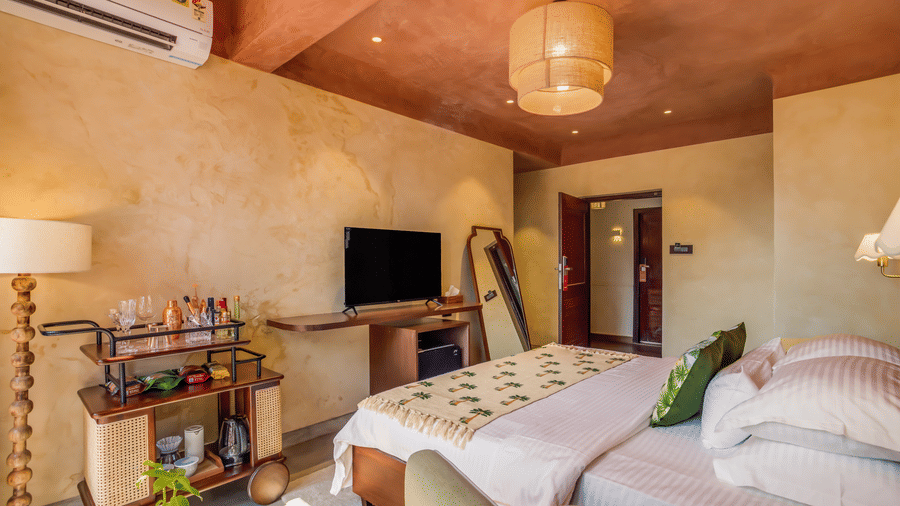 Inviting bedroom at Unseen Boutique Hotel with warm tones, modern furnishings, and a cozy atmosphere designed for comfort and style.