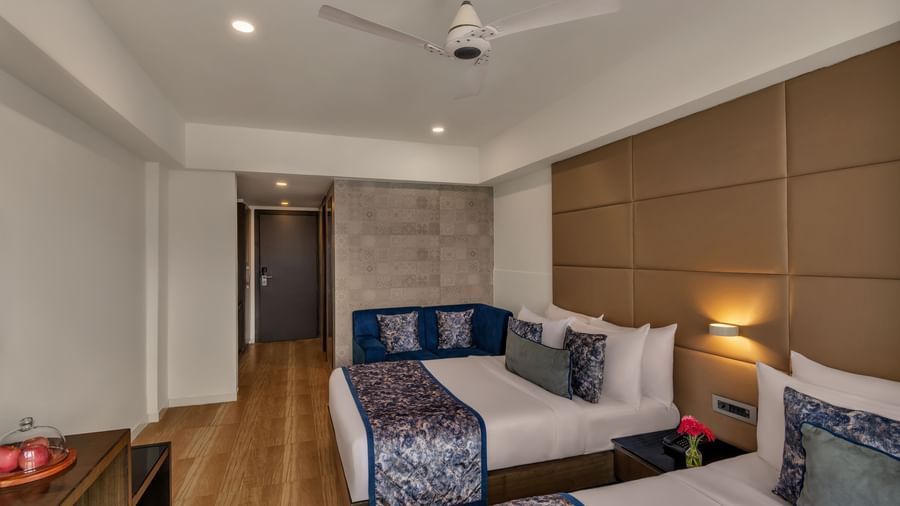 Guest room with twin beds at Voyage Milestone Hotel and Banquet.