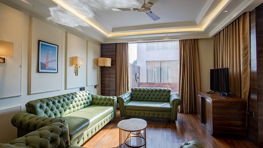 sofas with a table in the centre - Wedlock Greens Hotel Resorts Dhanbad