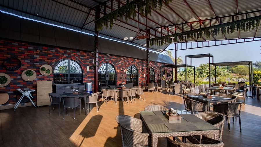 al fresco seating arrangements inside a restaurant - Wedlock Greens Hotel Resorts Dhanbad