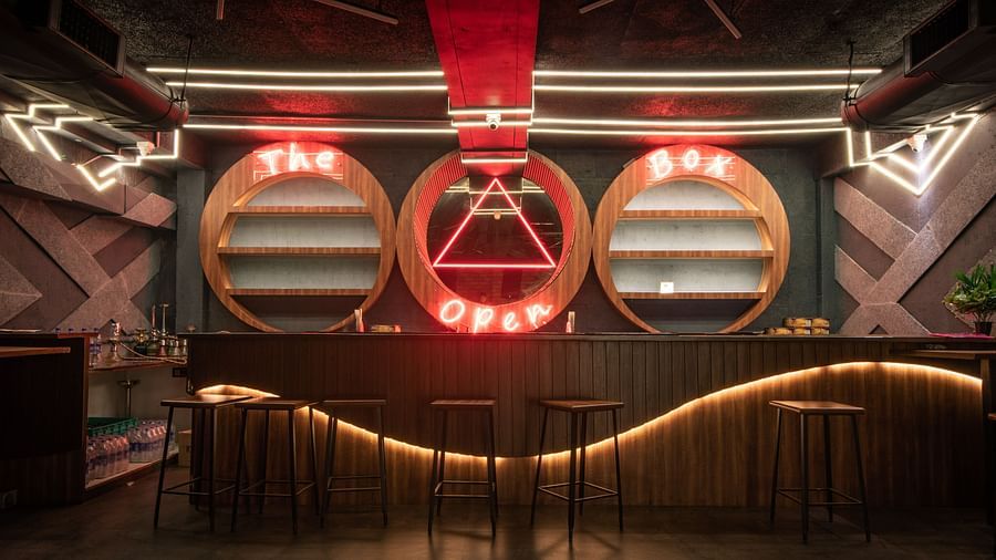 The counter at The Open Box boasts a quirky design, featuring circular niches in the walls with shelves neatly tucked inside - Wedlock Greens Hotel & Resort, Dhanbad