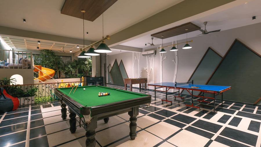 An indoor room with pool tables and modern decor at The Golden Tusk, Jim Corbett