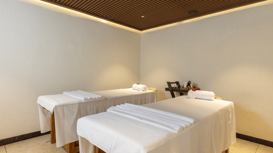  A double spa treatment room featuring two massage tables, suitable for parallel sessions at The Golden Tusk, Jim Corbett