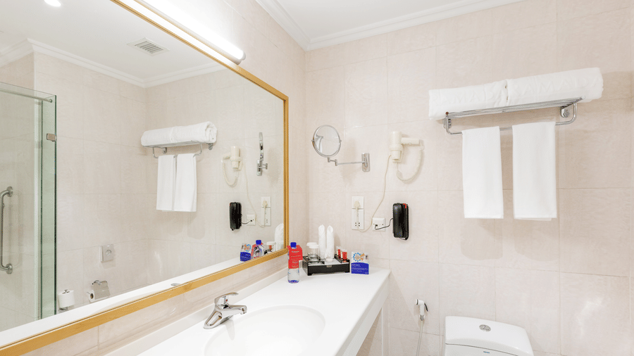 An overview of a bathroom with the sink area and commode in view - Ramada by Wyndham Addis, Addis Ababa.
