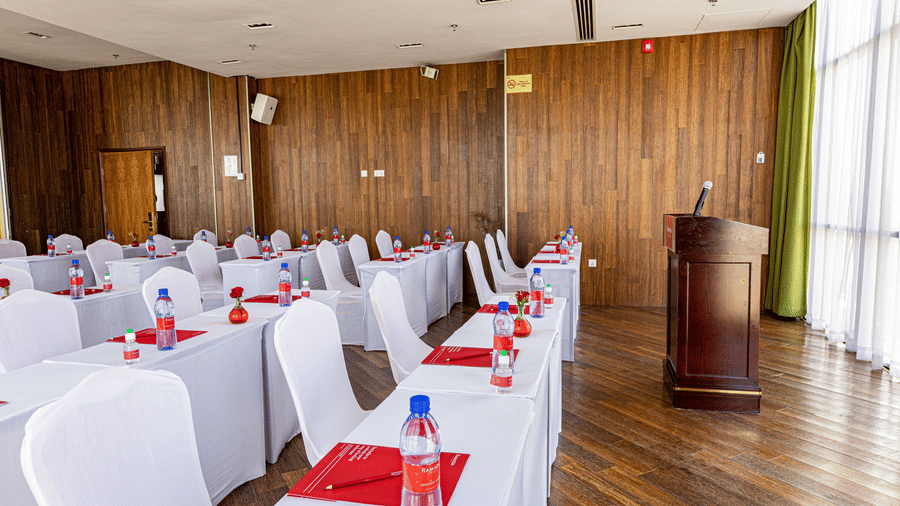 An overview of a meeting room with many tables and chairs in view - Ramada by Wyndham Addis, Addis Ababa.