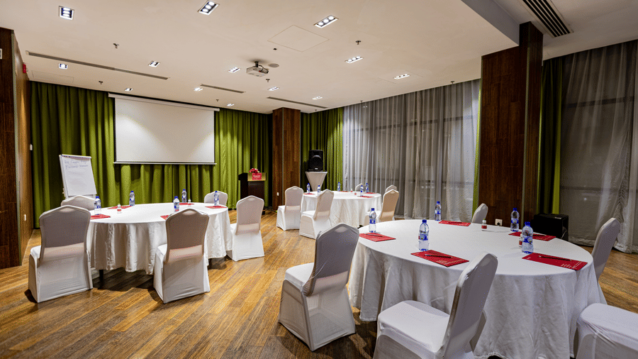 An overview of a meeting room with many tables and chairs in view - Ramada by Wyndham Addis, Addis Ababa.