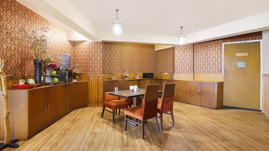 A full view of a dining area that has a dining table and four chairs | Summit Newa Regency & Spa, Pelling